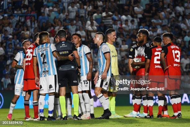 Players of Atletico Tucuman argue with referee Nazareno Arasa as Miguel Borja of River Plate holds the ball during a Copa de la Liga 2024 Group A...