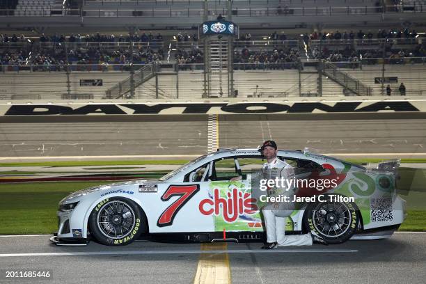 Corey LaJoie, driver of the Chili's Catch-a-Rita Chevrolet, poses for a photo on the grid during qualifying for the NASCAR Cup Series Daytona 500 at...