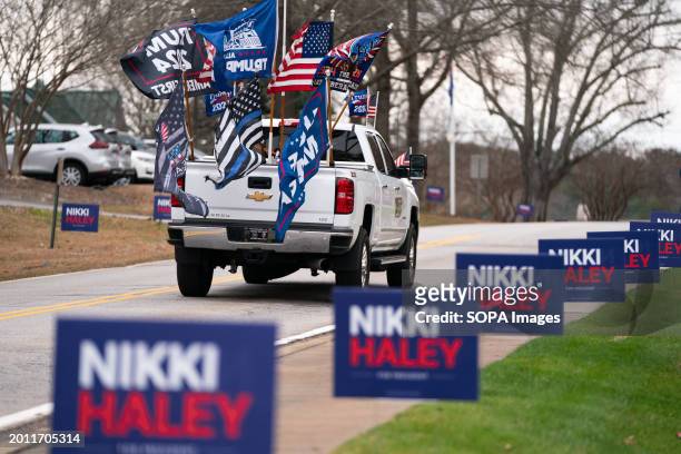 Supporter of former President Donald Trump drives past a campaign rally for Republican presidential candidate Nikki Haley in Irmo. South Carolina...