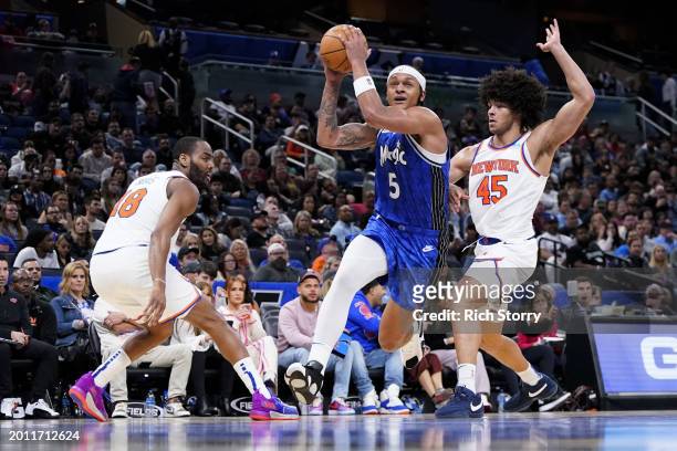 Paolo Banchero of the Orlando Magic drives to the basket against Jericho Sims of the New York Knicks during the fourth quarter at Kia Center on...