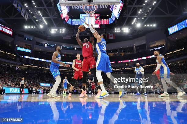 Bam Adebayo of the Miami Heat is defended by Giannis Antetokounmpo of the Milwaukee Bucks during a game at Fiserv Forum on February 13, 2024 in...