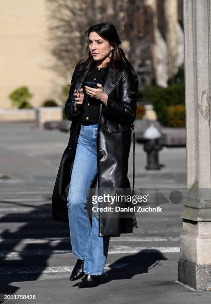 Guest is seen wearing a black faux leather coat, black top, blue jeans and black Chanel bag outside the Bevza show during NYFW F/W 2024 on February...
