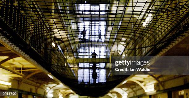 Prisoners at HMP Pentonville walk through an atrium May 19, 2003 in London. A new report from the Prison Reform Trust says overcrowding in Britain's...