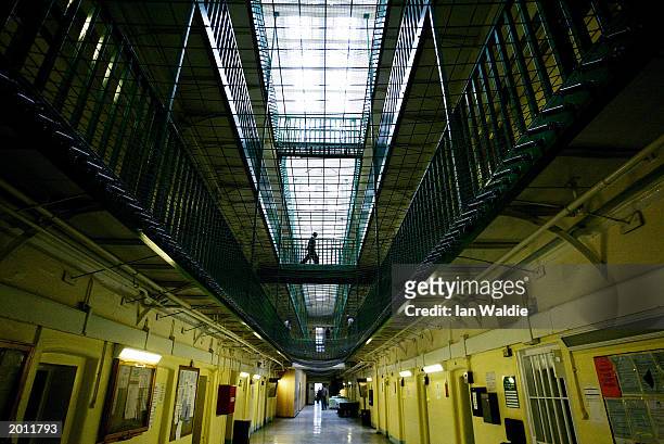 Prisoners at HMP Pentonville walk through an atrium May 19, 2003 in London. The Chief inspector of prisons Anne Owers will, in a report publishing...