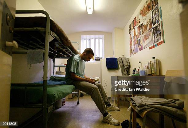 Prisoner reads a book in his cell at HMP Pentonville May 19, 2003 in London. A new report from the Prison Reform Trust says overcrowding in Britain's...