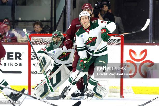 Goaltender Marc-Andre Fleury and Brock Faber of the Minnesota Wild defend the net against Jason Zucker of the Arizona Coyotes in the second period at...