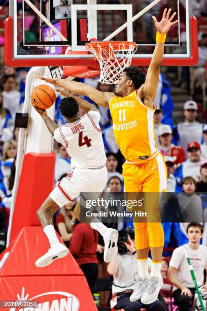 Davonte Davis of the Arkansas Razorbacks goes up for a shot in the second half under Tobe Awaka of the Tennessee Volunteers at Bud Walton Arena on...