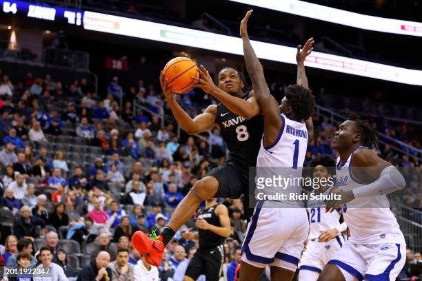 Quincy Olivari of the Xavier Musketeers attempts a shot as Kadary Richmond and David Tubek of the Seton Hall Pirates defend during the second half of...
