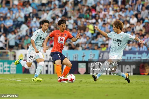 Ataru Esaka of Omiya Ardija controls the ball against Shohei Takakashi and Hayao Kawabe of Júbilo Iwata during the J.League J1 match between Júbilo...
