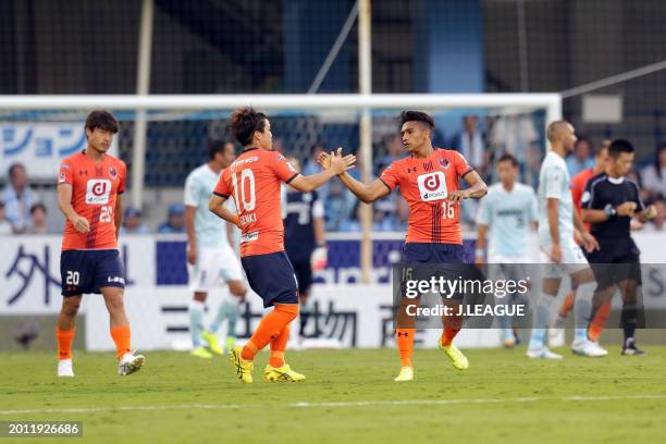 Mateus Castro of Omiya Ardija celebrates with teammate Genki Omae after scoring the team's first goal during the J.League J1 match between Júbilo...