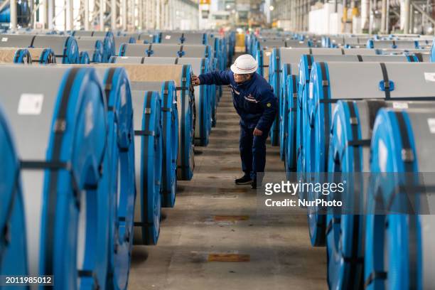 Workers are delivering steel coils at a workshop delivery area at the Hefei Circular Economy Demonstration Park in Hefei, China, on February 18, 2024.