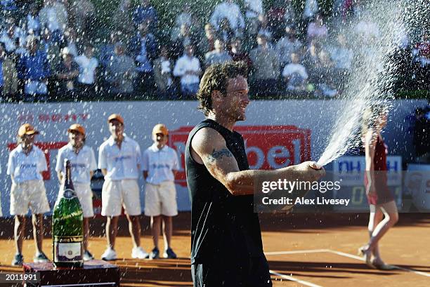 Carlos Moya of Spain sprays Cava after winning the Final of the ATP Seat Open held on April 27, 2003 at the Real Club de Tenis, in Barcelona, Spain....