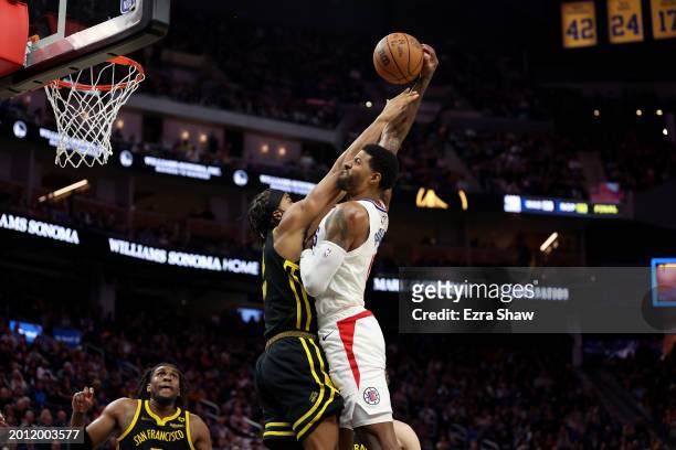 Paul George of the LA Clippers goes up for a dunk on Moses Moody of the Golden State Warriors in the second half at Chase Center on February 14, 2024...
