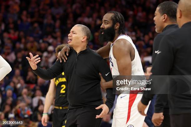 James Harden of the LA Clippers holds back head coach Tyronn Lue, who was complaining about a call, during their game against the Golden State...