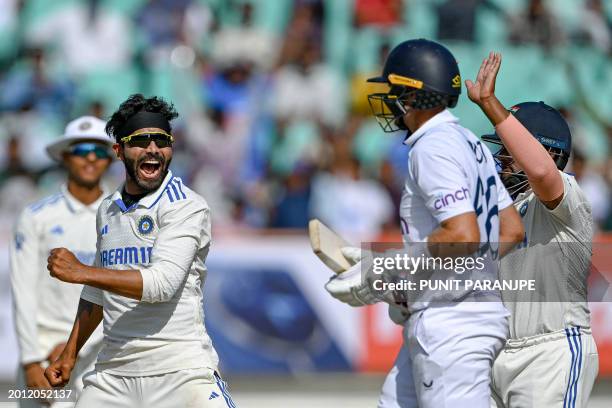 India's Ravindra Jadeja celebrates after taking the wicket of England's Joe Root during the fourth day of the third Test cricket match between India...
