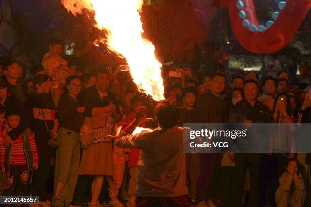 Tourists watch fire spitting performance at 'Nanning Night' block during the Spring Festival holiday on February 14, 2024 in Nanning, Guangxi Zhuang...