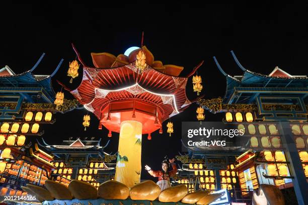 Tourists watch a performance at 'Nanning Night' block during the Spring Festival holiday on February 14, 2024 in Nanning, Guangxi Zhuang Autonomous...