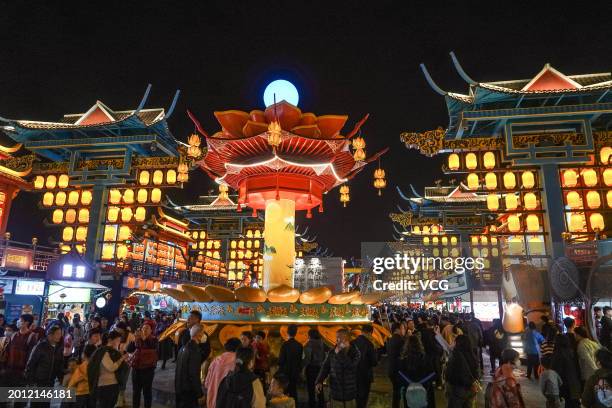 Tourists view lantern installations at 'Nanning Night' block during the Spring Festival holiday on February 14, 2024 in Nanning, Guangxi Zhuang...