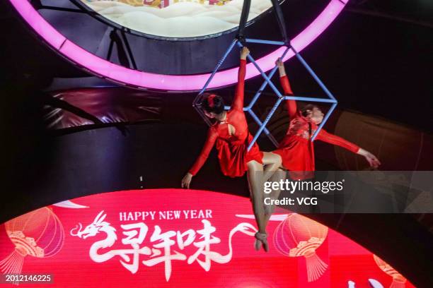 Aerobatic performance is staged to entertain tourists at 'Nanning Night' block during the Spring Festival holiday on February 14, 2024 in Nanning,...