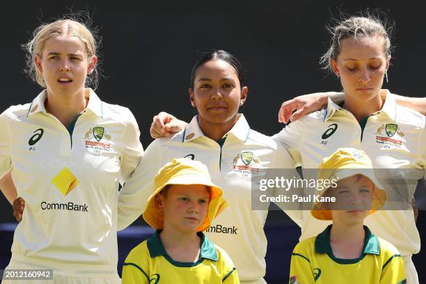 Phoebe Litchfield, Alana King and Ashleigh Gardner of Australia stand for the national anthem during day one of the Women's Test Match between...