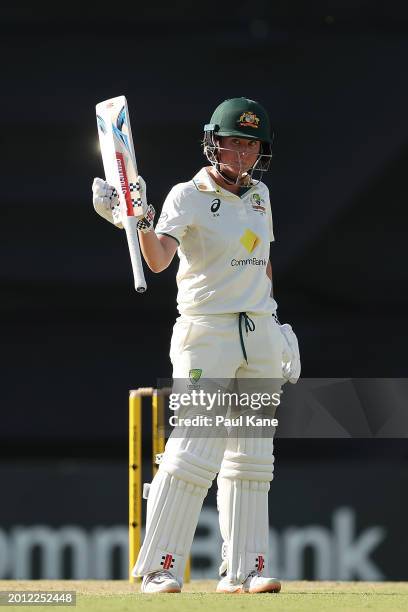 Beth Mooney of Australia raises her bat after reaching her half century during day one of the Women's Test Match between Australia and South Africa...