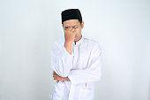 stressed asian man muslim rubbing his