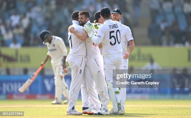 England bowler Mark Wood celebrates with team mates after taking the wicket of Rohit Sharma during day one of the 3rd Test Match between India and...