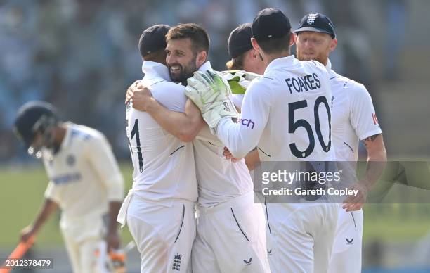 England bowler Mark Wood celebrates with team mates after taking the wicket of Rohit Sharma during day one of the 3rd Test Match between India and...