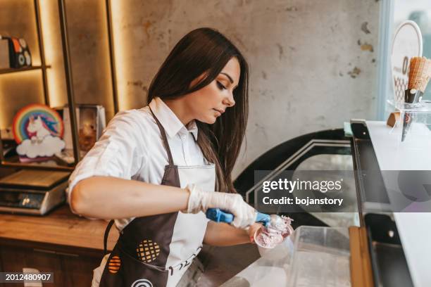 woman serving ice cream in confectionery shop - artisanal food and drink stock pictures, royalty-free photos & images