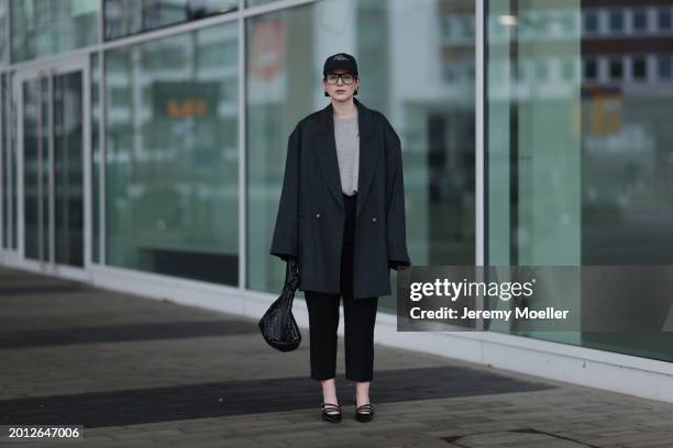 Maria Barteczko seen wearing Victoria Beckham black oversized aviator glasses, silver earrings, Frame x Ritz Paris dark blue logo baseball cap, Arket...