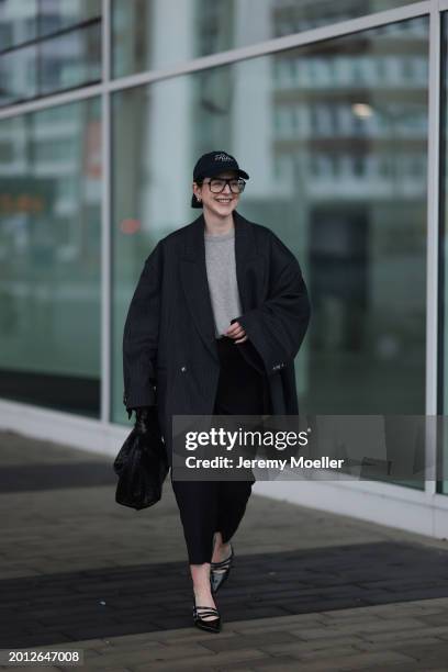 Maria Barteczko seen wearing Victoria Beckham black oversized aviator glasses, silver earrings, Frame x Ritz Paris dark blue logo baseball cap, Arket...