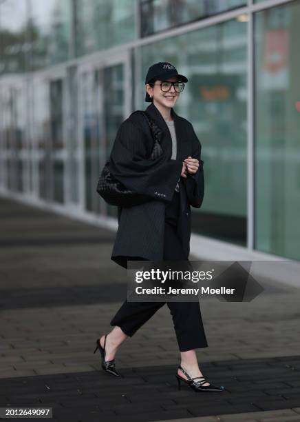 Maria Barteczko seen wearing Victoria Beckham black oversized aviator glasses, silver earrings, Frame x Ritz Paris dark blue logo baseball cap, Arket...