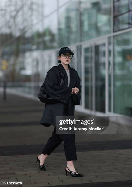 Maria Barteczko seen wearing Victoria Beckham black oversized aviator glasses, silver earrings, Frame x Ritz Paris dark blue logo baseball cap, Arket...