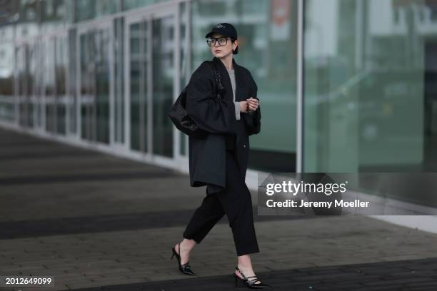 Maria Barteczko seen wearing Victoria Beckham black oversized aviator glasses, silver earrings, Frame x Ritz Paris dark blue logo baseball cap, Arket...