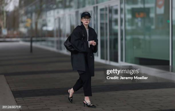 Maria Barteczko seen wearing Victoria Beckham black oversized aviator glasses, silver earrings, Frame x Ritz Paris dark blue logo baseball cap, Arket...