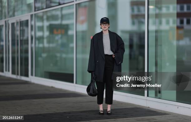 Maria Barteczko seen wearing Victoria Beckham black oversized aviator glasses, silver earrings, Frame x Ritz Paris dark blue logo baseball cap, Arket...