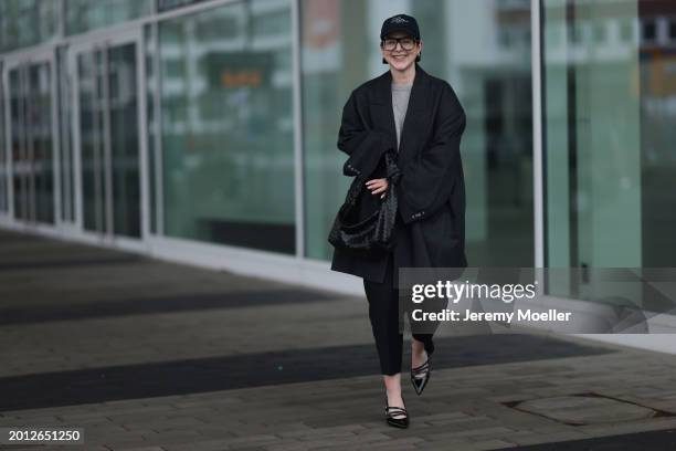 Maria Barteczko seen wearing Victoria Beckham black oversized aviator glasses, silver earrings, Frame x Ritz Paris dark blue logo baseball cap, Arket...