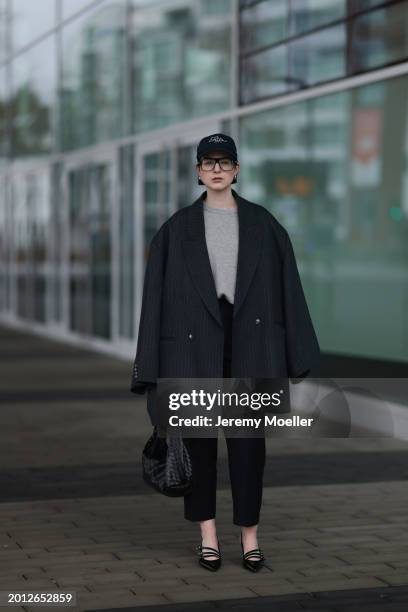 Maria Barteczko seen wearing Victoria Beckham black oversized aviator glasses, silver earrings, Frame x Ritz Paris dark blue logo baseball cap, Arket...