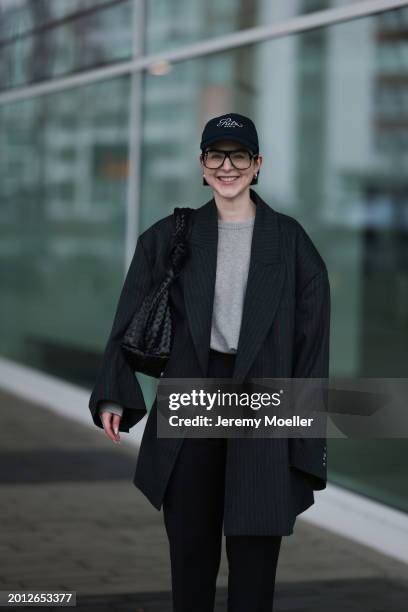 Maria Barteczko seen wearing Victoria Beckham black oversized aviator glasses, silver earrings, Frame x Ritz Paris dark blue logo baseball cap, Arket...