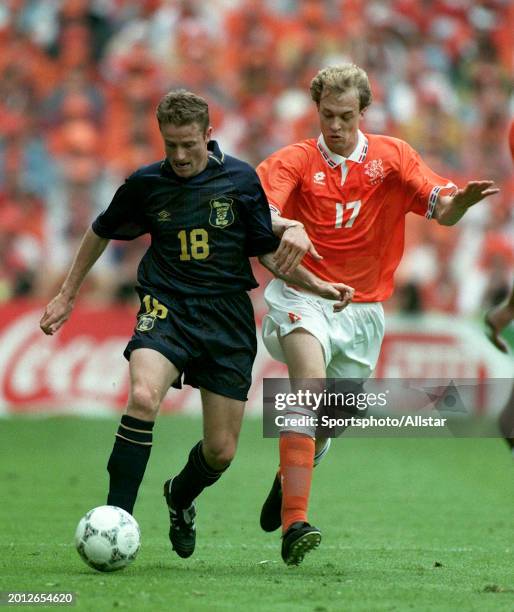 June 10: Kevin Gallacher of Scotland and Jordi Cruyff of Holland challenge during the UEFA Euro 1996 Group A match between Holland and Scotland at...