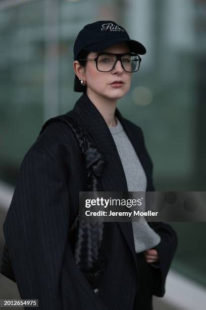 Maria Barteczko seen wearing Victoria Beckham black oversized aviator glasses, silver earrings, Frame x Ritz Paris dark blue logo baseball cap, Arket...