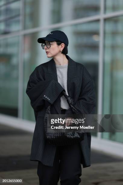 Maria Barteczko seen wearing Victoria Beckham black oversized aviator glasses, silver earrings, Frame x Ritz Paris dark blue logo baseball cap, Arket...