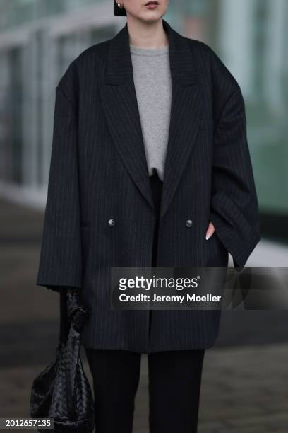 Maria Barteczko seen wearing silver earrings, Arket light grey wool knit sweater, VIVAL.STUDIO dark grey pinstripe oversized blazer jacket, Pixie...