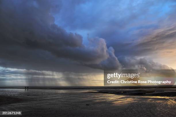 rain squall on the beach - squall stock pictures, royalty-free photos & images