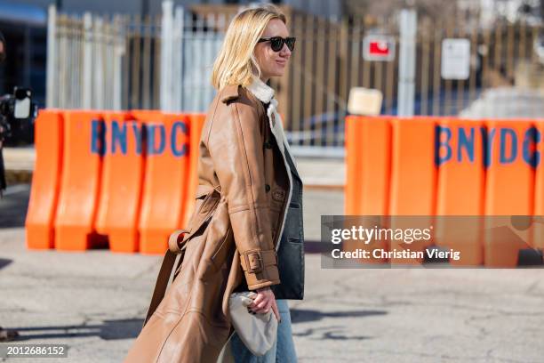 Lisa Aiken wears brown shearling coat, denim jeans, mini Bottega Veneta bag outside Brandon Maxwell on February 14, 2024 in New York City.