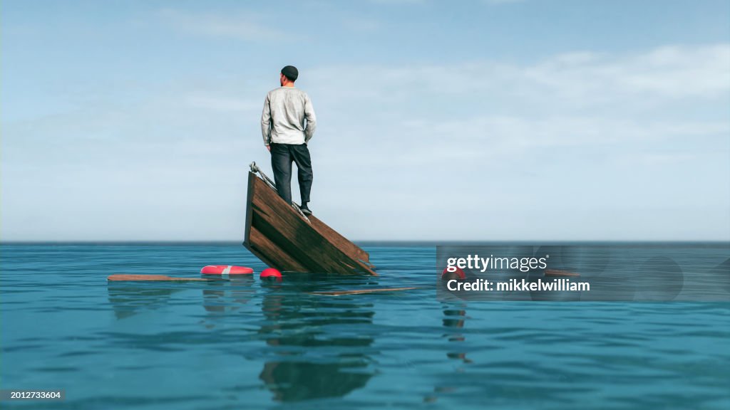 Rowboat sinks in the middle of the sea and man looks for solution