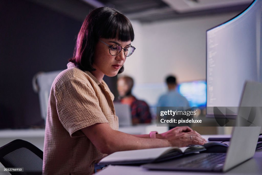 Professional IT worker working late, coding and machine learning working with AI.