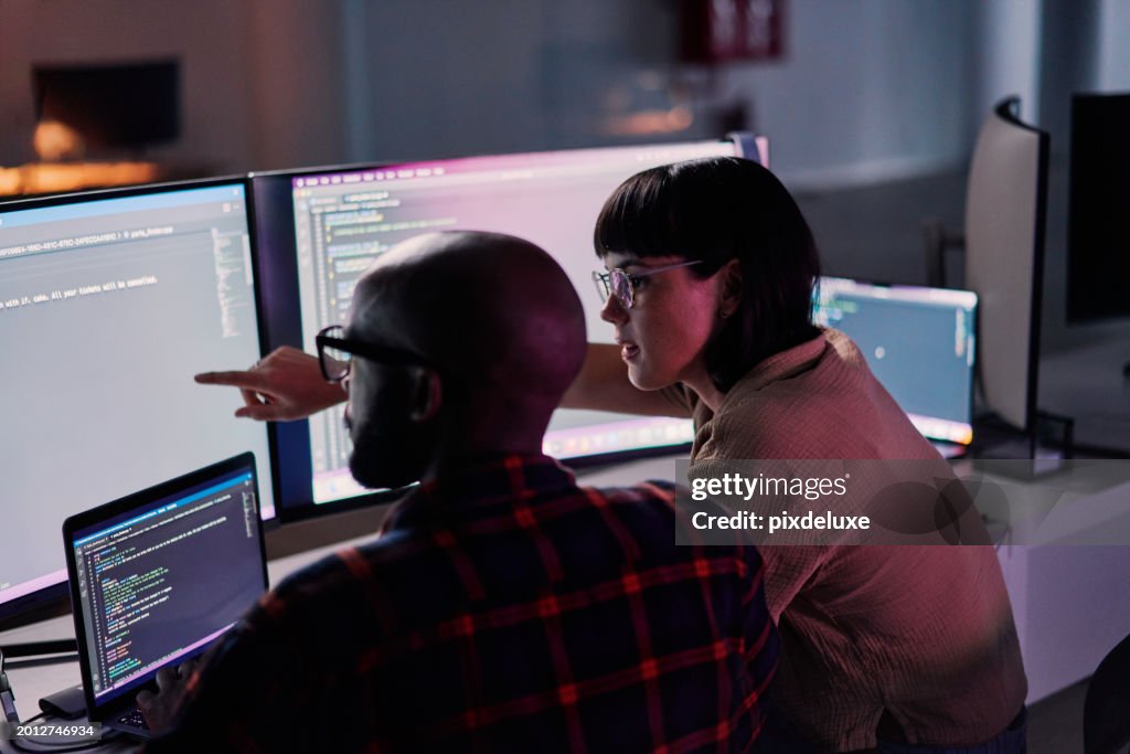 Creative developer, coding and team idea programming on computer in software or application development at office. 2 IT co-workers code on laptop or technology for testing, web design or online startup