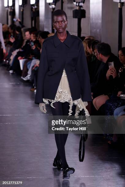 Model walks the runway at the Tory Burch A/W 2024 fashion show during New York Fashion Week at New York Public Library on February 12, 2024 in New...