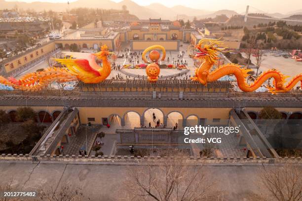 Aerial view of tourists visiting underground cave dwelling with festive decorations during the Spring Festival holiday on February 13, 2024 in...